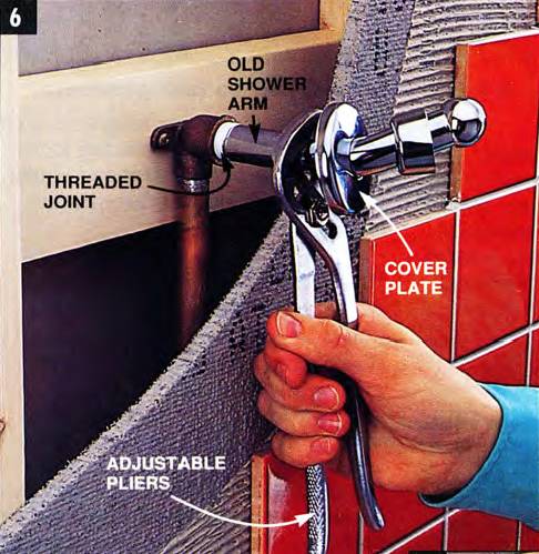 This diagram shows a cutout of the wall behind a shower arm - the threaded joint, the old shower arm connection, the wall cover plate, and the adjustable pliers to unscrew the shower arm