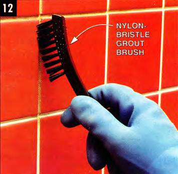 Scrub the grout with the phosphoric acid solution using a nylon-bristle grout brush