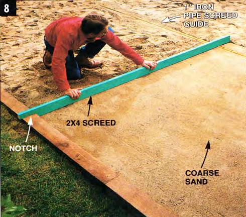 Use a straight 2x4 as a screed to spread and level the sand over the subbase